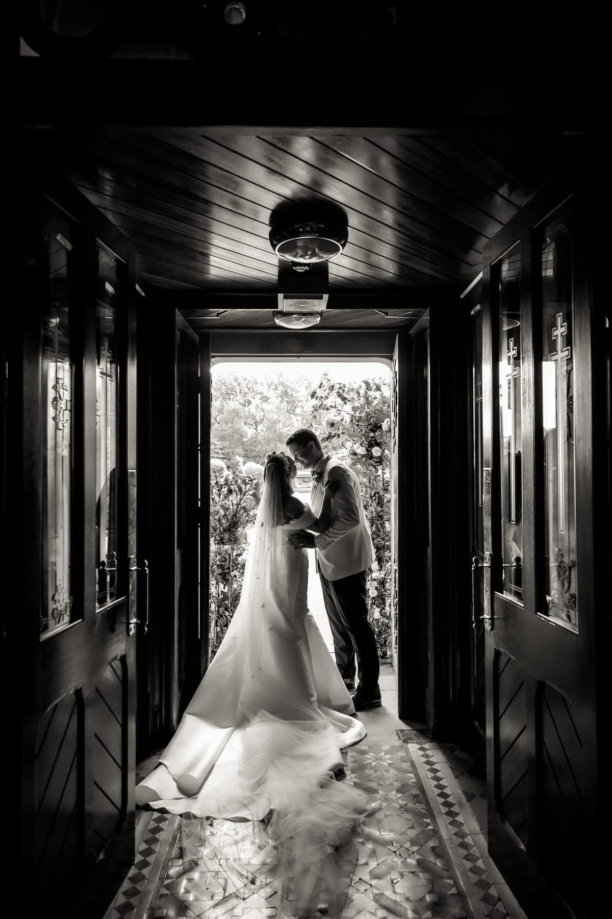 Couple embracing in a doorway, in black and white